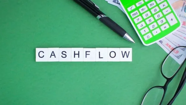 CASHFLOW text with office items and currency notes – Zidika Consulting, Kenya