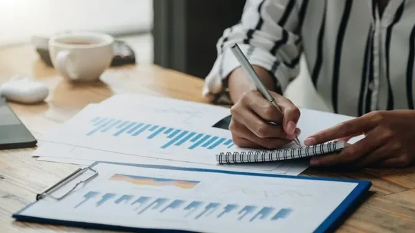 Woman in a Nairobi office recording accounting entries for her business – Zidika Consulting, Kenya