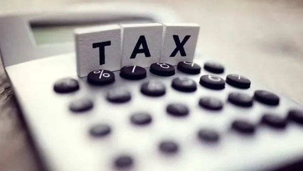 Wooden TAX blocks on top of a calculator for deduction planning – Zidika Consulting, Kenya