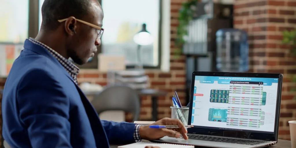Accountant automating finances with a laptop at a Kenyan business office